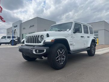 2024 Jeep Wrangler 4-door Sahara in a Bright White Clear Coat exterior color and Blackinterior. Legacy Auto Center 620-315-9264 legacyautocenter.net 