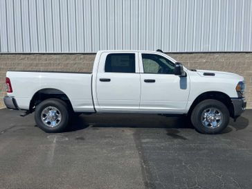 2024 RAM 2500 Tradesman Crew Cab 4x4 6'4' Box in a Bright White Clear Coat exterior color and Blackinterior. Wilmington Auto Center Chrysler Dodge Jeep Ram (937) 556-6430 wilmingtonautocentercdjr.com 