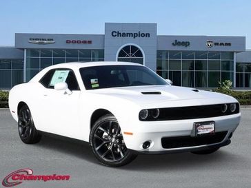2023 Dodge Challenger SXT in a White Knuckle exterior color and HOUNDSTOOTHinterior. Champion Chrysler Jeep Dodge Ram 800-549-1084 pixelmotiondemo.com 