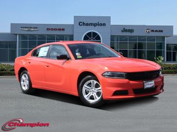 2023 Dodge Charger SXT Rwd in a Go Mango exterior color and HOUNDSTOOTHinterior. Champion Chrysler Jeep Dodge Ram 800-549-1084 pixelmotiondemo.com 