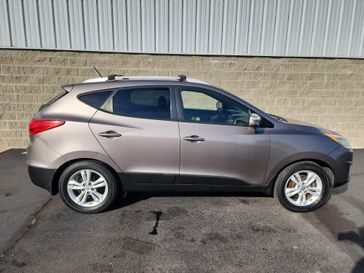 2012 Hyundai Tucson GLS in a Chai Bronze exterior color and Taupeinterior. Wilmington Auto Center Chrysler Dodge Jeep Ram (937) 556-6430 wilmingtonautocentercdjr.com 