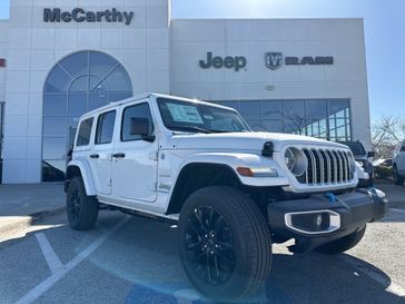 2024 Jeep Wrangler 4-door Sahara 4xe in a Bright White Clear Coat exterior color and Blackinterior. McCarthy Jeep Ram 816-434-0674 mccarthyjeepram.com 