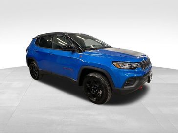 2024 Jeep Compass Trailhawk 4x4 in a Laser Blue Pearl Coat exterior color and Ruby Red/Blackinterior. Sheridan Motors CDJR 307-218-2217 sheridanmotor.com 
