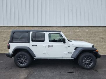 2024 Jeep Wrangler 4-door Sport S in a Bright White Clear Coat exterior color and Blackinterior. Wilmington Auto Center Chrysler Dodge Jeep Ram (937) 556-6430 wilmingtonautocentercdjr.com 