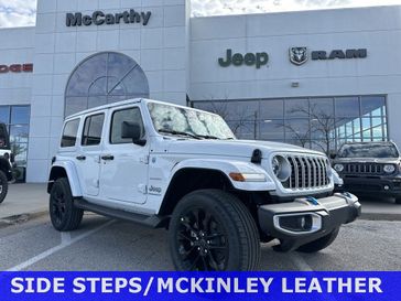 2024 Jeep Wrangler 4-door Sahara 4xe in a Bright White Clear Coat exterior color. McCarthy Jeep Ram 816-434-0674 mccarthyjeepram.com 
