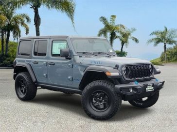 New 2024 Jeep Wrangler 4xE Willys 4xe in a Gray exterior color and Blackinterior. Southbay Chrysler Jeep Dodge Ram (424) 404-5521 pixelmotiondemo.com 