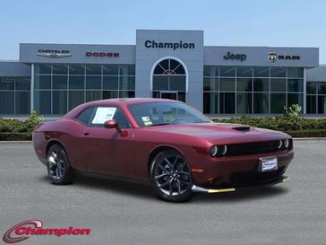 2023 Dodge Challenger Gt in a Octane Red exterior color and HOUNDSTOOTHinterior. Champion Chrysler Jeep Dodge Ram 800-549-1084 pixelmotiondemo.com 