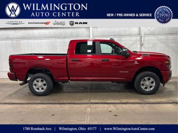 New 2026 RAM 2500 Big Horn Crew Cab 4x4 6'4' Box in a Molten Red Pearl Coat exterior color and Blackinterior. Wilmington Auto Center Chrysler Dodge Jeep Ram (937) 556-4751 wilmingtonautocentercdjr.com 