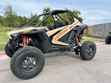 2024 POLARIS RZR TURBO R ULTIMATE  MILITARY TAN in a TAN exterior color. Family PowerSports (877) 886-1997 familypowersports.com 