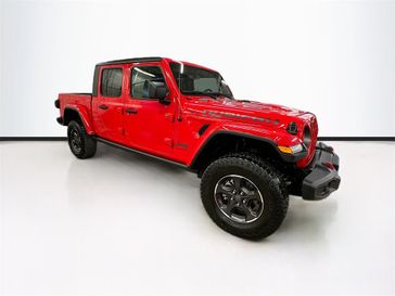 2023 Jeep Gladiator Rubicon 4x4 in a Firecracker Red Clear Coat exterior color and Blackinterior. Sheridan Motors CDJR 307-218-2217 sheridanmotor.com 