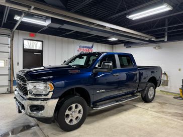 Used 2024 RAM 2500 Big Horn in a Patriot Blue Pearl Coat exterior color and Black/Diesel Grayinterior. Jensen Chrysler Dodge Jeep Ram 507-354-0542 jensenchryslerdodgejeepram.com 