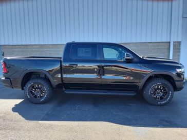 2025 RAM 1500 Rebel Crew Cab 4x4 5'7' Box in a Diamond Black Crystal Pearl Coat exterior color and Blackinterior. Wilmington Auto Center Chrysler Dodge Jeep Ram (937) 556-6430 wilmingtonautocentercdjr.com 