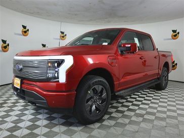 2023 Ford F-150 Lightning Lariat in a Rapid Red Metallic Tinted Clear Coat exterior color and Blackinterior. Ontario Auto Center ontarioautocenter.com 