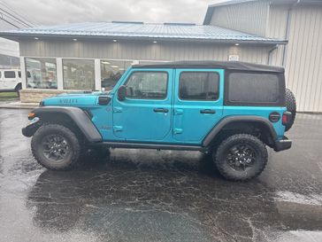 2024 Jeep Wrangler 4-door Willys 4xe in a Bikini Pearl Coat exterior color and Blackinterior. Victor Chrysler Dodge Jeep Ram 585-236-4391 victorcdjr.com 
