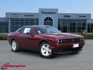 2023 Dodge Challenger SXT in a Octane Red exterior color and HOUNDSTOOTH CLOinterior. Champion Chrysler Jeep Dodge Ram 800-549-1084 pixelmotiondemo.com 