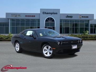2023 Dodge Challenger SXT in a Pitch-Black exterior color and HOUNDSTOOTH CLOinterior. Champion Chrysler Jeep Dodge Ram 800-549-1084 pixelmotiondemo.com 