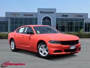 2023 Dodge Charger SXT Rwd in a Go Mango exterior color and HOUNDSTOOTHinterior. Champion Chrysler Jeep Dodge Ram 800-549-1084 pixelmotiondemo.com 