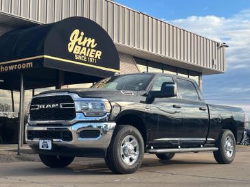 2024 RAM 2500 Tradesman Crew Cab 4x4 6'4' Box in a Diamond Black Crystal Pearl Coat exterior color. Jim Baier Inc 319-372-1012 jimbaier.com 