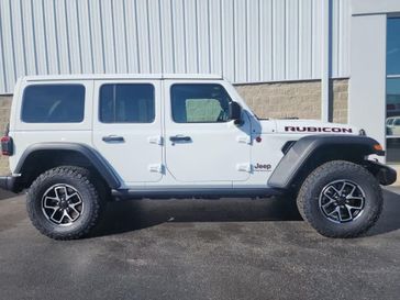 2024 Jeep Wrangler 4-door Rubicon in a Bright White Clear Coat exterior color and Blackinterior. Wilmington Auto Center Chrysler Dodge Jeep Ram (937) 556-6430 wilmingtonautocentercdjr.com 