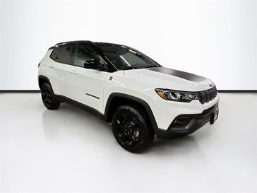2024 Jeep Compass Trailhawk 4x4 in a Bright White Clear Coat exterior color and Ruby Red/Blackinterior. Sheridan Motors CDJR 307-218-2217 sheridanmotor.com 