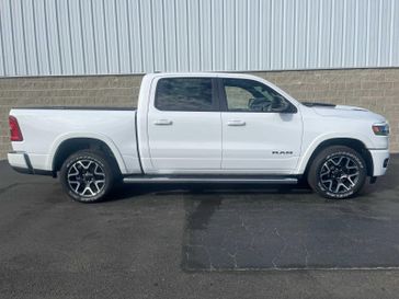 2025 RAM 1500 Laramie Crew Cab 4x4 5'7' Box in a Bright White Clear Coat exterior color and Blackinterior. Wilmington Auto Center Chrysler Dodge Jeep Ram (937) 556-6430 wilmingtonautocentercdjr.com 