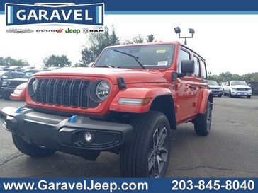 2024 Jeep Wrangler 4-door Sport S 4xe in a Firecracker Red Clear Coat exterior color and Blackinterior. Garavel Jeep 475-258-7987 norwalkjeep.com 