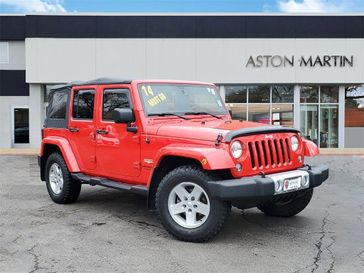 2014 Jeep Wrangler JK Unlimited Sahara in a Firecracker Red Clear Coat exterior color and Blackinterior. Lotus of Glenview 847-904-1233 lotusofglenview.com 