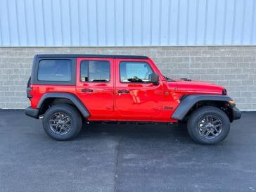 2024 Jeep Wrangler 4-door Sport S in a Firecracker Red Clear Coat exterior color and Blackinterior. Wilmington Auto Center Chrysler Dodge Jeep Ram (937) 556-6430 wilmingtonautocentercdjr.com 