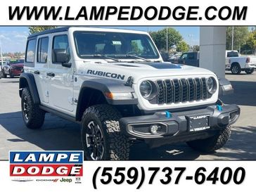 2024 Jeep Wrangler 4-door Rubicon 4xe in a Bright White Clear Coat exterior color and Blackinterior. Lampe Chrysler Dodge Jeep RAM 559-471-3085 pixelmotiondemo.com 
