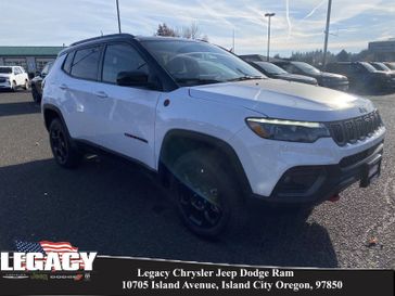 2023 Jeep Compass Trailhawk 4x4 in a Bright White Clear Coat exterior color and Ruby Red/Blackinterior. Legacy Chrysler Jeep Dodge RAM 541-663-4885 legacychryslerjeepdodgeram.com 
