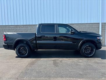 2025 RAM 1500 Rebel Crew Cab 4x4 5'7' Box in a Diamond Black Crystal Pearl Coat exterior color and Blackinterior. Wilmington Auto Center Chrysler Dodge Jeep Ram (937) 556-6430 wilmingtonautocentercdjr.com 