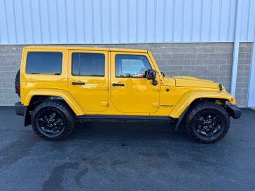 2015 Jeep Wrangler Unlimited Altitude in a Baja Yellow Clear Coat exterior color and Blackinterior. Wilmington Auto Center Chrysler Dodge Jeep Ram (937) 556-6430 wilmingtonautocentercdjr.com 