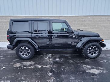 2024 Jeep Wrangler 4-door Sahara in a Black Clear Coat exterior color and Blackinterior. Wilmington Auto Center Chrysler Dodge Jeep Ram (937) 556-6430 wilmingtonautocentercdjr.com 