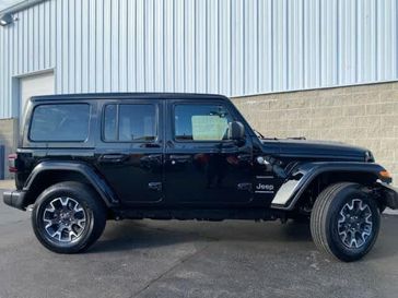 2024 Jeep Wrangler 4-door Sahara in a Black Clear Coat exterior color and Blackinterior. Wilmington Auto Center Chrysler Dodge Jeep Ram (937) 556-6430 wilmingtonautocentercdjr.com 