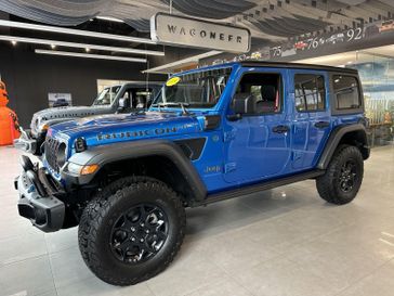 2023 Jeep Wrangler Rubicon 4xe in a Hydro Blue Pearl Coat exterior color and Red/Blackinterior. Victor Chrysler Dodge Jeep Ram 585-236-4391 victorcdjr.com 