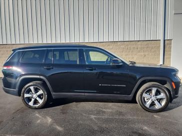 2021 Jeep Grand Cherokee L Limited in a Diamond Black Crystal Pearl Coat exterior color and Wicker Beige/Blackinterior. Wilmington Auto Center Chrysler Dodge Jeep Ram (937) 556-6430 wilmingtonautocentercdjr.com 