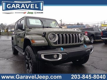 2024 Jeep Wrangler 4-door Sahara 4xe in a Sarge Green Clear Coat exterior color. Garavel Jeep 475-258-7987 norwalkjeep.com 