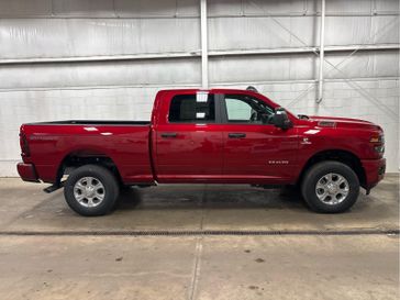 New 2026 RAM 2500 Big Horn Crew Cab 4x4 6'4' Box in a Molten Red Pearl Coat exterior color and Blackinterior. Wilmington Auto Center Chrysler Dodge Jeep Ram (937) 556-4751 wilmingtonautocentercdjr.com 