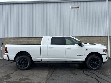 2024 RAM 2500 Laramie Mega Cab 4x4 6'4' Box in a Bright White Clear Coat exterior color. Wilmington Auto Center Chrysler Dodge Jeep Ram (937) 556-6430 wilmingtonautocentercdjr.com 