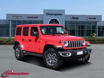 2024 Jeep Wrangler 4-door Sahara in a Firecracker Red Clear Coat exterior color and CLOTHinterior. Champion Chrysler Jeep Dodge Ram 800-549-1084 pixelmotiondemo.com 