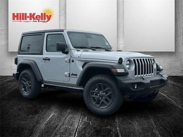 2024 Jeep Wrangler 2-door Sport S in a Silver Zynith Clear Coat exterior color and Blk Cl Sprt Msh Sdso Stinterior. Hill-Kelly Dodge (850) 786-2130 hillkellydodge.com 