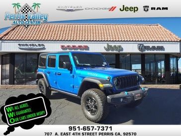 2024 Jeep Wrangler 4-door Willys 4xe in a Hydro Blue Pearl Coat exterior color and Blackinterior. Perris Valley Chrysler Dodge Jeep Ram 951-355-1970 perrisvalleydodgejeepchrysler.com 