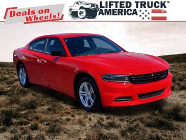 2023 Dodge Charger SXT in a Torred Clear Coat exterior color and Blackinterior. Lifted Truck America 888-267-0644 liftedtruckamerica.com 