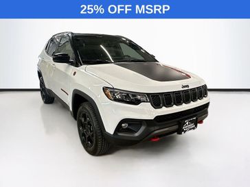 2023 Jeep Compass Trailhawk 4x4 in a Bright White Clear Coat exterior color and Ruby Red/Blackinterior. Sheridan Motors CDJR 307-218-2217 sheridanmotor.com 