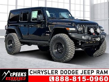 2023 Jeep Wrangler 4-door Rubicon 392 in a Black Clear Coat exterior color and Red/Blackinterior. McPeek's Chrysler Dodge Jeep Ram of Anaheim 888-861-6929 mcpeeksdodgeanaheim.com 