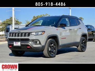 2024 Jeep Compass Trailhawk in a Sting-Gray Clear Coat exterior color and Ruby Red/Blackinterior. Ventura Auto Center 866-978-2178 venturaautocenter.com 