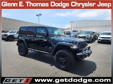 2023 Jeep Wrangler Rubicon 4xe in a Black Clear Coat exterior color and Red/Blackinterior. Glenn E Thomas 100 Years Of Excellence (866) 340-5075 getdodge.com 