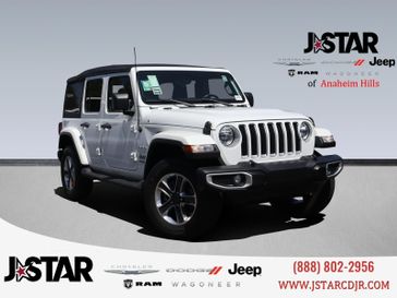 2021 Jeep Wrangler Unlimited Sahara in a Bright White Clear Coat exterior color and Blackinterior. J Star Chrysler Dodge Jeep Ram of Anaheim Hills 888-802-2956 jstarcdjrofanaheimhills.com 