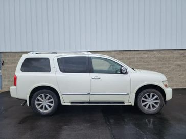 2010 INFINITI QX56  in a Tuscan Pearl Metallic exterior color and Stoneinterior. Wilmington Auto Center Chrysler Dodge Jeep Ram (937) 556-6430 wilmingtonautocentercdjr.com 