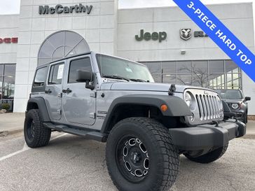 2015 Jeep Wrangler Unlimited Sport in a Billet Silver Metallic Clear Coat exterior color and Blackinterior. McCarthy Jeep Ram 816-434-0674 mccarthyjeepram.com 